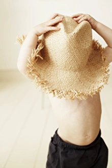 Eighteen-month-old boy wearing a large hat. Print