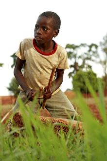 Images Dated 30th April 2007: Uganda Boy Playing Drum Print