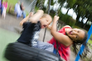 Children's Playground Scene Print: Young Girl and Boy on a Tyre Swing