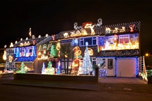 Prints of Christmas lights. Row of houses adorned with Christmas lights and ornaments at night Images Dated 2009 September: Christmas Lights Print