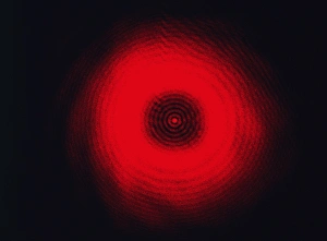 Prints of Diffraction pattern created by shining a monochromatic (single wavelength) light at a circular object. The light waves bend and spread around the object and converge Images Dated 2005 June: Monochromatic Light Diffraction Pattern Print