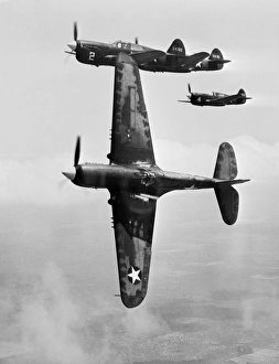 Prints of US Air Force fighter pilot training. Formation of P-40 Warhawk fighter planes during a training flight. The lead plane is peeling off for the attack Images Dated 2012 December: 1943 US Air Force P-40 Warhawk Formation Training Print