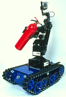 Prints of Robot firefighter. Robot designed to fight fires in hazardous areas, such as chemical plants or nuclear reactors. This robot is fitted with a video camera on its top Images Dated 1998 February: Robot Firefighter Print: Autonomous Robot with Extinguisher and Camera