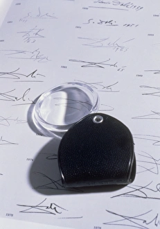 Magnifying glass on sheet of real Dali signatures Magnifying glass on sheet of real Dali signatures
