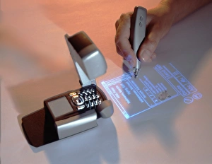 Prints of Mobile phone with integrated projector. This prototype mobile phone is able to project its display onto any flat surface Images Dated 2005 June: Mobile Phone with Projector Print