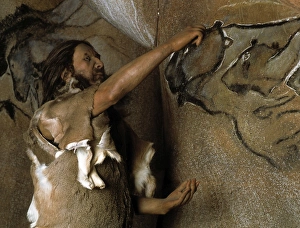Model of a Cro-Magnon man doing a cave painting Model of a Cro-Magnon man doing a cave painting