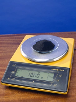 Prints of One mole of carbon. Carbon powder being weighed out on a balance. 12 grams of carbon is 1 mole. A mole is a chemical unit of measurement that shows the number of molecules or atoms present Images Dated 2004 February: One mole of carbon: A Print