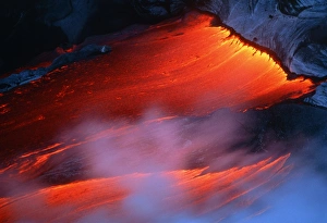 Molten pahoehoe lava spilling from a lava tube Molten pahoehoe lava spilling from a lava tube