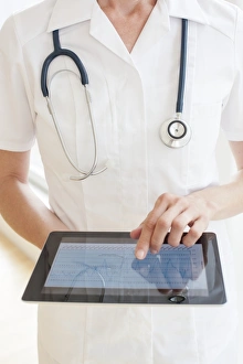 Medical Technology Images Prints: Nurse using a tablet computer F008 / 2918