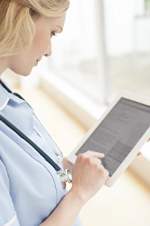 Medical Tablets Prints: Nurse using a tablet computer F008 / 3067