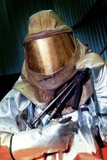 Prints of MODEL RELEASED. Oxy-acetylene welding. Worker in heavy heat-resistant protective clothing holding oxy-acetylene welding equipment Images Dated 2011 May: Oxy-acetylene welding Print