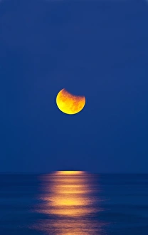 Partial Lunar Eclipse Prints: Partially eclipsed setting moon