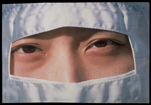 Pharmaceutical technician in clean room clothing Pharmaceutical technician in clean room clothing