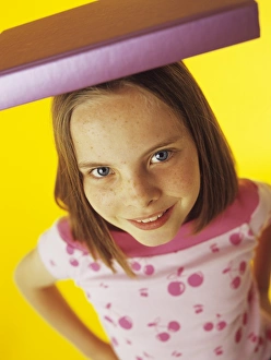 Posture improvement Print: An 8-year-old girl balancing a book on her head