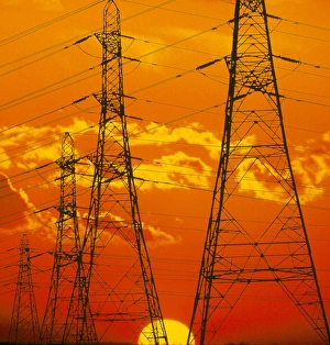 Pylons carrying electricity wires at sunset Pylons carrying electricity wires at sunset