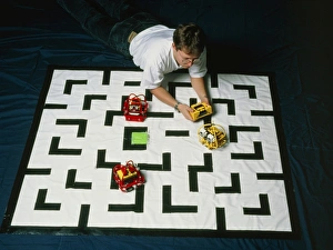 Researcher testing Lego robots playing Pacman Researcher testing Lego robots playing Pacman