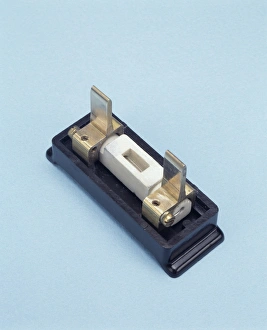 Prints of Rewirable electrical fuse. Single-bladed rewirable fuse carrier, designed to protect electrical devices and people from excessive amounts of electricity Images Dated 2004 July: Rewirable Electrical Fuse Print