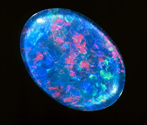 Prints of Opal. A piece of blue, iridescent opal. Opal is composed of microspheroids of hydrous silicon oxide. It is the refraction of light within these spheroids which gives the mineral its iridescent sheen Images Dated 2002 September: Blue Opal Print
