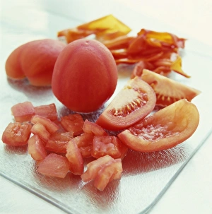 Prints of Skinned tomatoes. They have been skinned by being blanched, placed in boiling water for a short time. Discarded skins are seen at upper right Images Dated 2004 August: Skinned Tomatoes Print