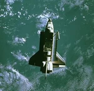 Space shuttle Challenger orbiting earth Space shuttle Challenger orbiting earth
