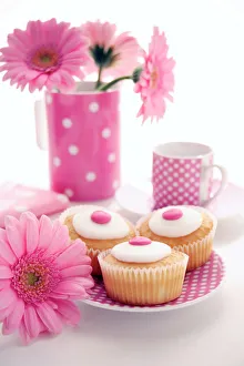 Prints of Tea party. Decorated cakes on a saucer surrounded by gerbera flowers Images Dated 2006 December: Tea Party Print: Decorated Cakes with Gerbera Flowers