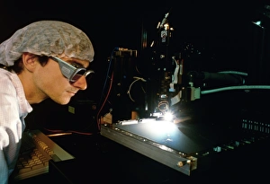 Technician supervising solar cell manufacture Technician supervising solar cell manufacture