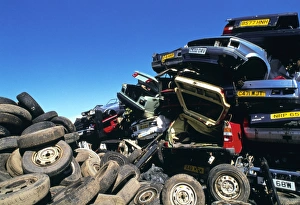 View of tyres and scrapped cars in a scrapyard View of tyres and scrapped cars in a scrapyard