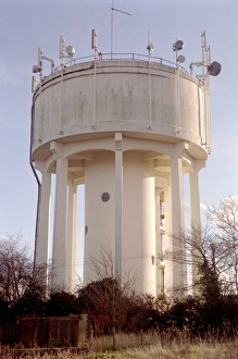 Prints of Water tower with mobile telephone and television transmitting antennae. The water tower stores water for homes and businesses in the surrounding area Images Dated 2004 February: Water Tower with Antennae Print