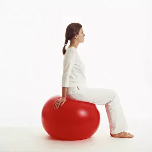 Images Dated 27th March 2003: Woman sitting on exercise ball
