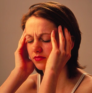 Young woman suffering a headache or migraine Young woman suffering a headache or migraine