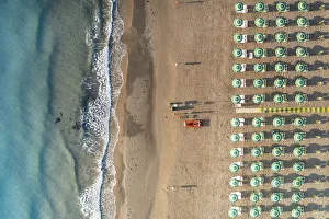 Aerial view of beach umbrellas and sunbeds in tidy rows during summer, Vieste Aerial view of beach umbrellas and sunbeds in tidy rows during summer, Vieste