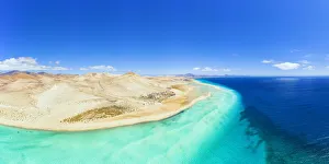 Aerial view of desert landscape of Jandia Nature Park washed by crystal sea, Costa Calma Aerial view of desert landscape of Jandia Nature Park washed by crystal sea, Costa Calma