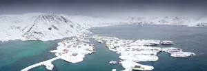 Aerial view of mountains and sea surrounding Sorvaer after a snow blizzard, Soroya Island Aerial view of mountains and sea surrounding Sorvaer after a snow blizzard, Soroya Island
