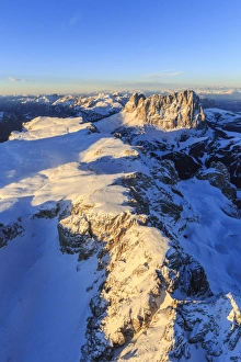 Aerial view of Sassolungo and Grohmann peaks at sunset, Sella Group, Dolomites Aerial view of Sassolungo and Grohmann peaks at sunset, Sella Group, Dolomites