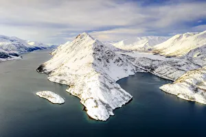 Aerial view of snow capped mountains along the clear water of Altafjord Aerial view of snow capped mountains along the clear water of Altafjord