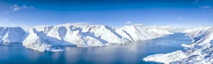 Aerial view of snow capped mountains and fjord during the cold arctic winter, Oksfjord Aerial view of snow capped mountains and fjord during the cold arctic winter, Oksfjord