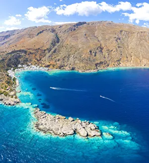 Aerial view of the village of Loutro nestled in the idyllic cove washed by turquoise sea, Crete island, Greek Islands Aerial view of the village of Loutro nestled in the idyllic cove washed by turquoise sea, Crete island, Greek Islands