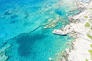 Aerial view of yacht moored in the crystal clear sea, Crete island, Greek Islands, Greece, Europe Aerial view of yacht moored in the crystal clear sea, Crete island, Greek Islands, Greece, Europe