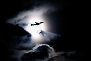 Aircraft taking off from Heathrow passing in front of full moon, London Aircraft taking off from Heathrow passing in front of full moon, London