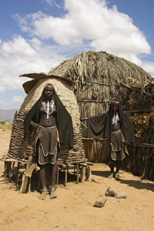 Ari women standing outside house, Lower Omo Valley, Ethiopia, Africa Ari women standing outside house, Lower Omo Valley, Ethiopia, Africa