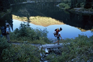 American West Coast Landscapes Prints: Backpacker crossing bridge