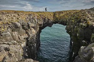 Polar Regions Landscape Prints: A basalt lava arch in the cliffs at the village of Arnastapi