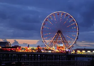 Big wheel and funfair on Central Pier lit at dusk, Blackpool Illuminations, Blackpool Big wheel and funfair on Central Pier lit at dusk, Blackpool Illuminations, Blackpool
