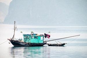Boats in Ha Long bay on a foggy morning, Quang Ninh Province, Vietnam, Indochina Boats in Ha Long bay on a foggy morning, Quang Ninh Province, Vietnam, Indochina