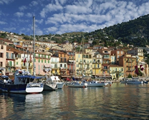 Boats in the harbour and painted houses on the waterfront in the town of Villefranche Boats in the harbour and painted houses on the waterfront in the town of Villefranche