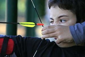 Prints of Boy doing archery, Forges-les-Eaux, Seine Maritime, France, Europe Tour Prints: Archery Print, Boy Targeting the Bullseye