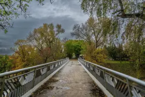 Prints of Bridge in Gomel park offers a view of trees and sky in autumn with grey clouds overhead in Gomel, Belarus Belarus Prints: Autumn Bridge Print in Gomel, Belarus
