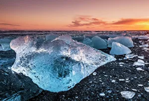 Broken ice from washed up icebergs on Jokulsarlon black beach at sunset, Jokulsarlon Broken ice from washed up icebergs on Jokulsarlon black beach at sunset, Jokulsarlon