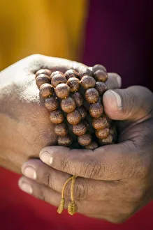 A Buddhist monk holds prayer beads (Japa Mala), Bodhnath, Nepal, Asia A Buddhist monk holds prayer beads (Japa Mala), Bodhnath, Nepal, Asia