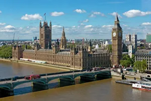 Buses crossing Westminster Bridge by Houses of Parliament, London, England Buses crossing Westminster Bridge by Houses of Parliament, London, England